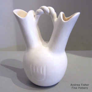 Bear paw imprints and a twisted handle on a white wedding vase