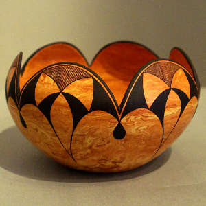 Geometric design on a Mixed clay jar with a scalloped rim