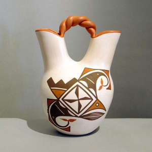 Bird element, medallion and geometric design on a polychrome wedding vase with a twisted handle