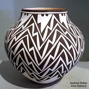 A lightning bolt and geometric design in black on a white jar