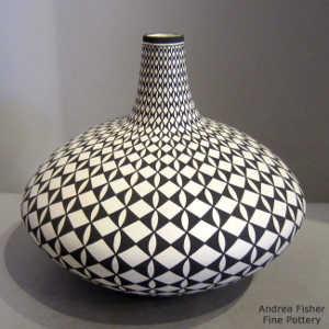 Geometric design on a black and white tall neck seed pot