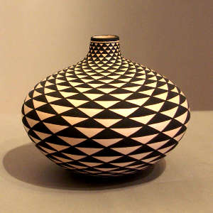 Spiral mesa geometric design on a black and white jar