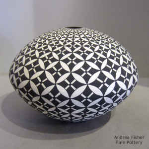 Pumpkin seed geometric design on a black and white seed pot