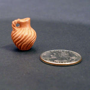 Swirl carved miniature red pitcher