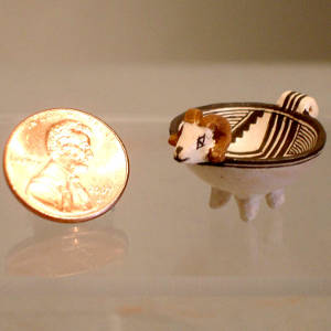 Geometric design on a goat effigy bowl with feet