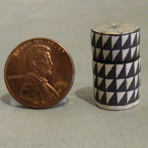 Stepped black and white design on a tiny lidded cylinder