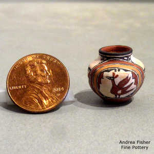 Bird, rainbow and geometric design on a miniature polychrome jar