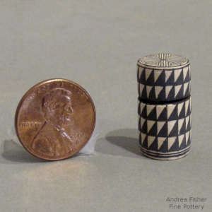 Spiral mesa geometric design on a miniature lidded black and white jar