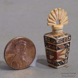 Tiny shard and geometric design on a miniature lidded polychrome jar