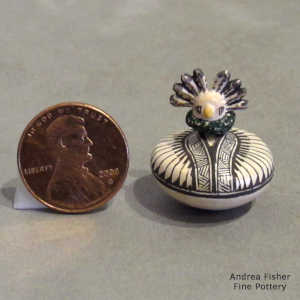 Geometric design on a square carved miniature jar