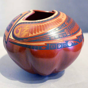 Sgraffito and painted geometric design on a red ribbed melon jar with an organic opening