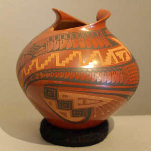 Geometric design on a polychrome red jar with an organic opening