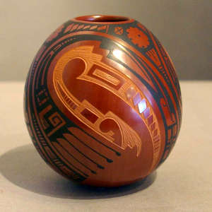 A sgraffito and painted geometric design on a polychrome jar