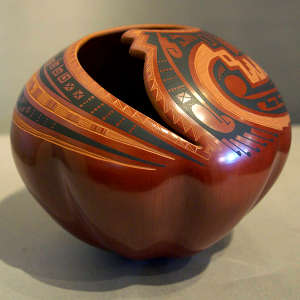 Sgraffito and painted geometric design around an organic opening on a polychrome jar with a melon-shaped base
