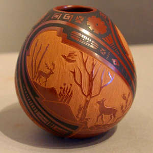 Sgraffito wildlife design and painted geometric design on a polychrome jar