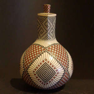 Geometric design on a polychrome lidded long neck jar