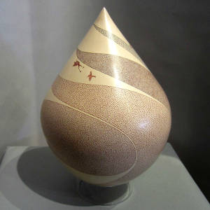 Fine line geometric and hummingbird design on a polychrome sculptural piece