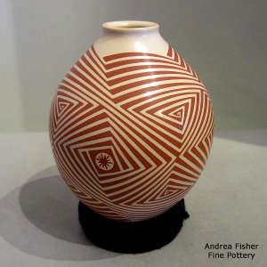 Geometric design in red on a beige jar