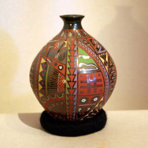Black jar decorated with multi-colored Paquime shard designs