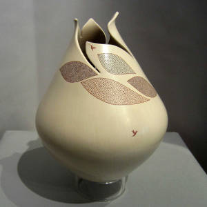 Painted geometric and hummingbird design on a polychrome jar with an organic opening