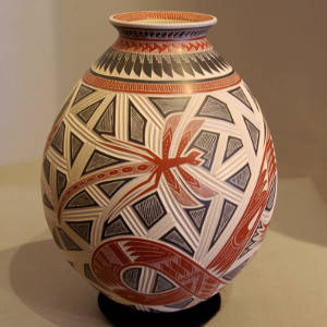 Sgraffito frog, Aztec serpent, dragonfly and parrot on a jar with a delicatley carved ribbed background