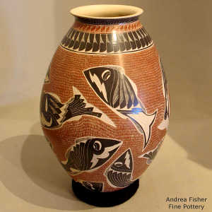 Sgraffito and painted fish, mesh and geometrric design on a polychrome jar