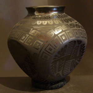 Paquime geometric designs on a black on black four sided jar