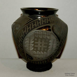 Geometric design on a four-sided graphite black on black jar