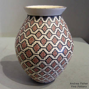 Sgraffito and painted red and black design on a buff-colored jar
