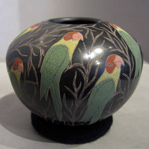 Sgraffito and painted parrot and branch design on a polychrome jar