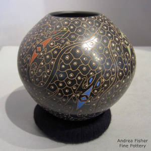 Sgraffito and painted designs on a black jar