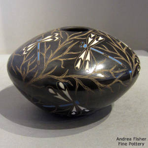 Sgraffito and painted tree branches and dragonflies motif on a polychrome jar