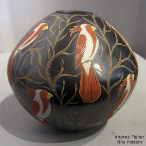 Sgraffito and painted parrot and branches motif on a polychrome jar