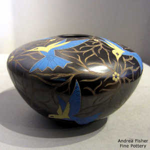 Sgraffito and painted hummingbird, flower and branch design on a poychrome jar