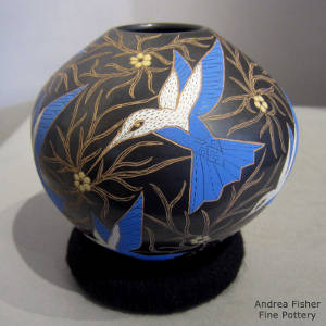 Sgraffito hummingbird and floral motif on a black jar
