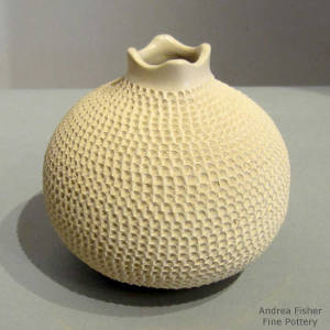 Corrugted surfce and a square opening on a white jar