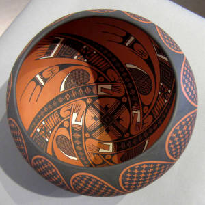 Bird element and geometric design inside and geometric design outside on a polychrome bowl
