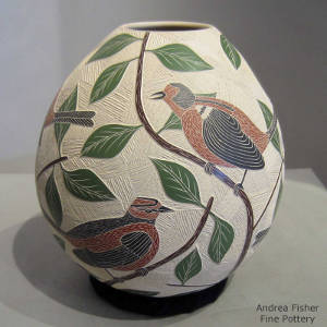 Sgraffito and painted bird, branch and leaf design on a polychrome jar
