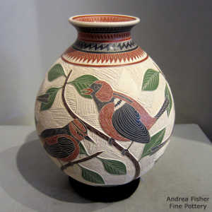 Sgraffito and painted branch, bird and geometric design on a polychrome jar