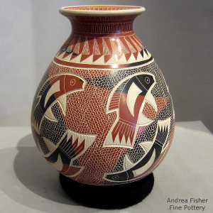 Sgraffito and painted fish, mesh and geometric design on a polychrome jar