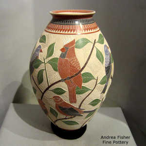 Sgraffito and painted branch, bird and geometric design on a polychrome jar