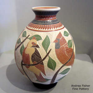 Lightly carved, sgraffito and painted branch, bird and geometric design on a polychrome jar