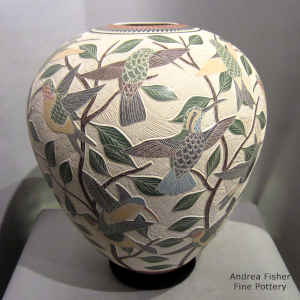 Sgraffito and painted bird, branch and geometric design on a polychrome jar