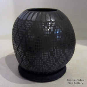 Geometric design on a squarish black on black jar