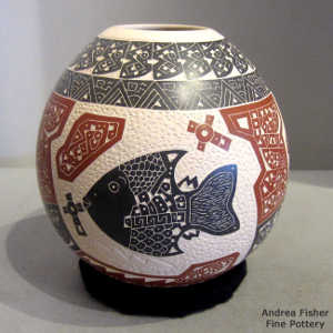 Sgraffito fish, texture and geometric design on a polychrome jar