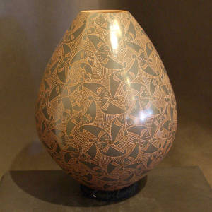 Sgraffito fish and geometric design on a brown jar
