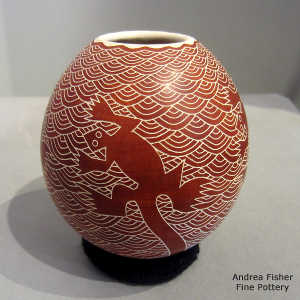 Sgraffito lizard, clamshell and geometric design on a red and white jar