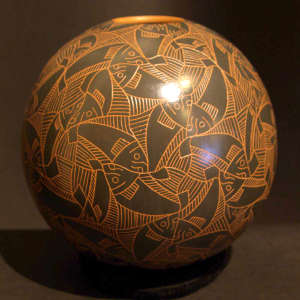 Sgraffito fish and geometric design on a red and black jar
