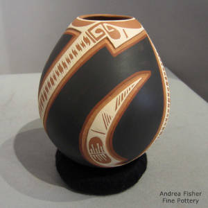 Geometric design carved and painted on a polychrome jar