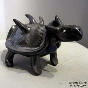 Geometric design on a black on black dinosaur figure